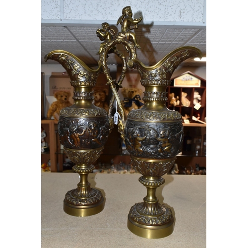 429 - A PAIR OF BRONZED BRASS EWERS, decorated with a bacchanalian design, Putti and grapevine, height 59c... 