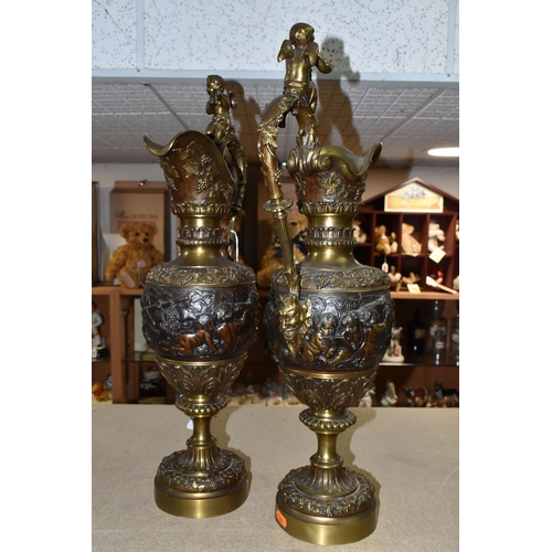 429 - A PAIR OF BRONZED BRASS EWERS, decorated with a bacchanalian design, Putti and grapevine, height 59c... 