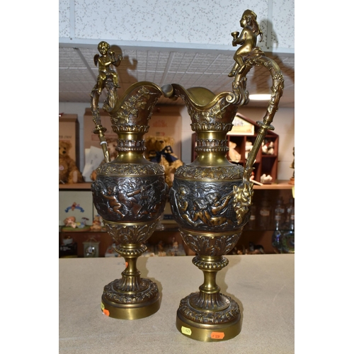 429 - A PAIR OF BRONZED BRASS EWERS, decorated with a bacchanalian design, Putti and grapevine, height 59c... 