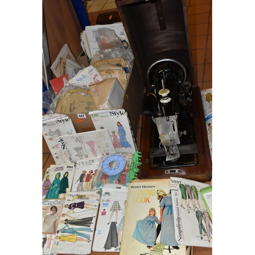 447 - TWO VINTAGE SEWING MACHINES AND A QUANTITY OF SEWING PATTERNS, to include a wooden cased Singer sewi... 