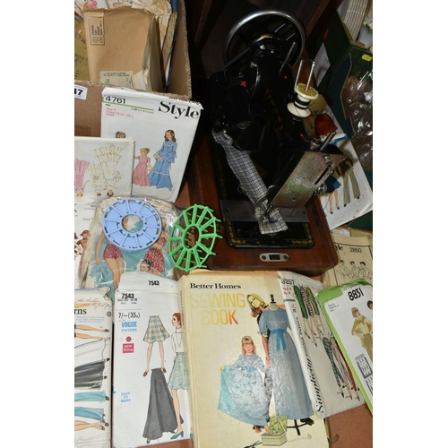 447 - TWO VINTAGE SEWING MACHINES AND A QUANTITY OF SEWING PATTERNS, to include a wooden cased Singer sewi... 