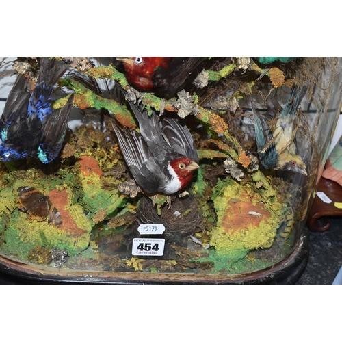 454 - TAXIDERMY: A VICTORIAN GLASS DOME OF HUMMINGBIRDS AND OTHER EXOTIC BIRDS, approximate height 55cm x ... 