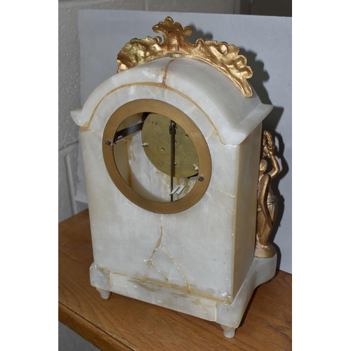 461 - TWO CLOCKS, comprising a white marble cased mantel clock with brocot escapement, two gilt metal wing... 