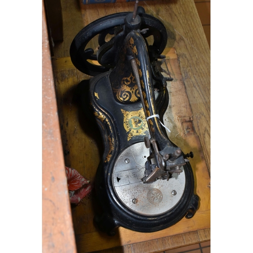 565 - A CASED JONES HAND SEWING MACHINE, swan neck, in black with rubbed gilt decoration, some paint loss ... 