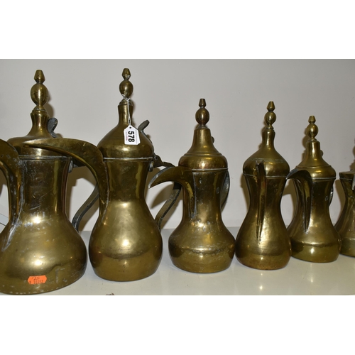 578 - TEN LATE 19TH / 20TH CENTURY MIDDLE EASTERN BRASS DALLAH, some with residual tinning, eight plain an... 