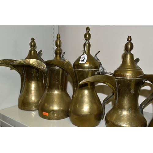 578 - TEN LATE 19TH / 20TH CENTURY MIDDLE EASTERN BRASS DALLAH, some with residual tinning, eight plain an... 