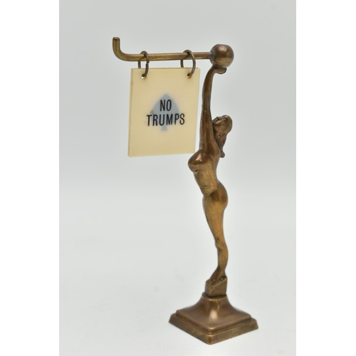 120A - AN ART DECO BRASS FEMALE NUDE BRIDGE MARKER, the figure holding a bar with five double sided suits /... 