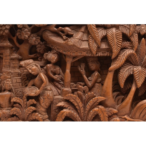 135A - A SECOND HALF 20TH CENTURY BALINESE HIGH RELIEF CARVED RECTANGULAR TEAK PANEL, depicting figures and... 