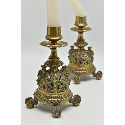 195A - A PAIR OF VICTORIAN BRASS CANDLESTICKS, flowerhead shaped drip pans, short turned pedestals and pier... 