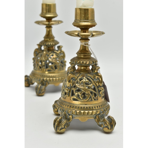 195A - A PAIR OF VICTORIAN BRASS CANDLESTICKS, flowerhead shaped drip pans, short turned pedestals and pier... 