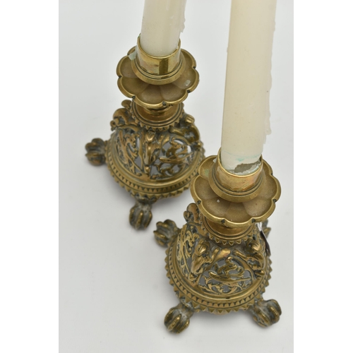 195A - A PAIR OF VICTORIAN BRASS CANDLESTICKS, flowerhead shaped drip pans, short turned pedestals and pier... 