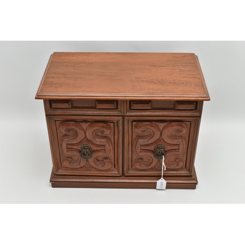 210A - A LATE 20TH CENTURY WALNUT AND TEAK JEWELLERY CASKET, the hinged top opening to reveal a mirror and ... 