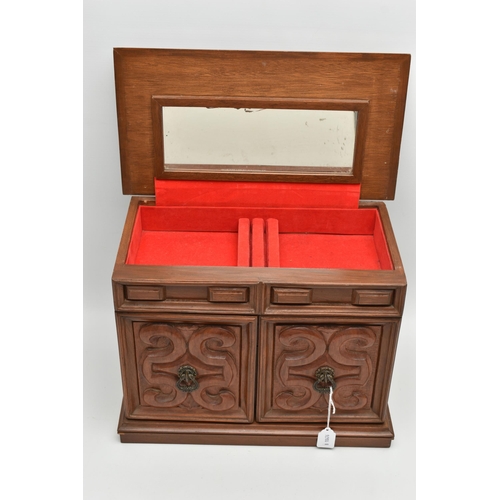 210A - A LATE 20TH CENTURY WALNUT AND TEAK JEWELLERY CASKET, the hinged top opening to reveal a mirror and ... 