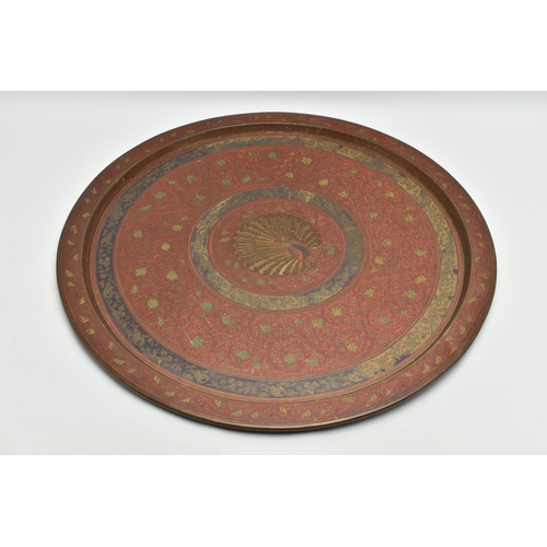 215A - A MID 20TH CENTURY INDIAN BRASS TRAY WITH ENAMELLED AND ENGRAVED DECORATION, with a peacock design t... 