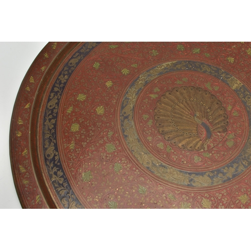 215A - A MID 20TH CENTURY INDIAN BRASS TRAY WITH ENAMELLED AND ENGRAVED DECORATION, with a peacock design t... 