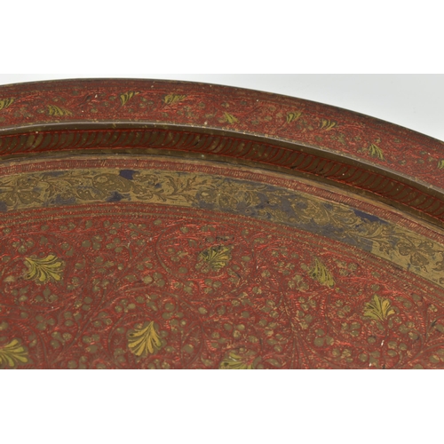 215A - A MID 20TH CENTURY INDIAN BRASS TRAY WITH ENAMELLED AND ENGRAVED DECORATION, with a peacock design t... 