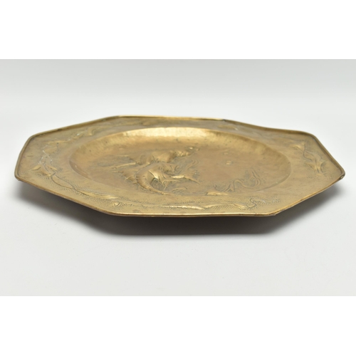 230A - MANNER OF JOHN PEARSON, AN OCTAGONAL ARTS & CRAFTS BRASS CHARGER, embossed with two fish to the cent... 