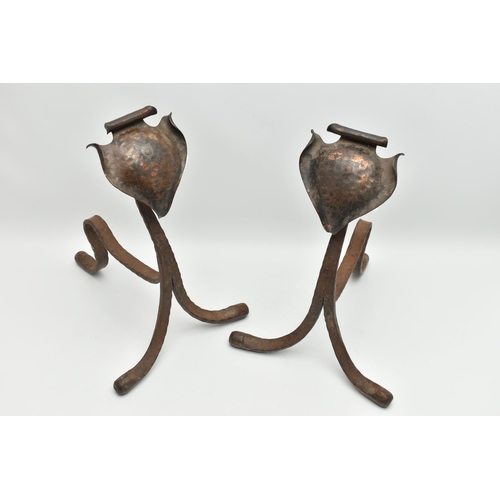 370A - A PAIR OF ARTS AND CRAFTS PLANISHED COPPER AND WROUGHT IRON FIRE DOGS, with scrolled spade shaped te... 