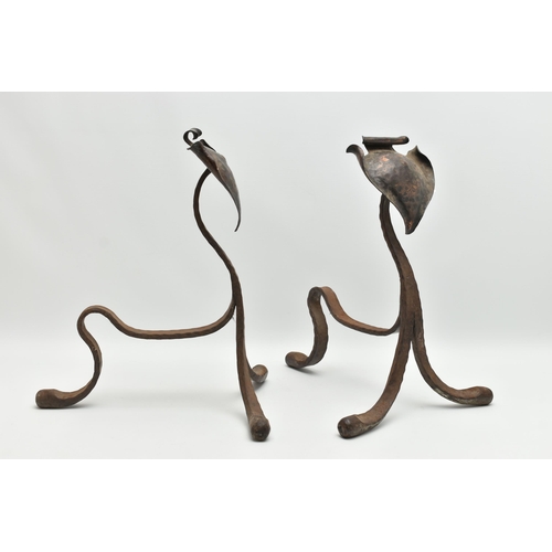 370A - A PAIR OF ARTS AND CRAFTS PLANISHED COPPER AND WROUGHT IRON FIRE DOGS, with scrolled spade shaped te... 