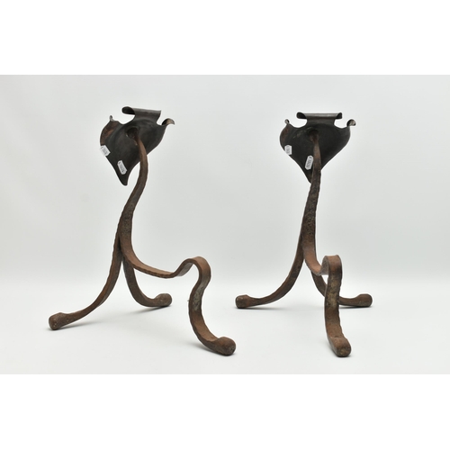 370A - A PAIR OF ARTS AND CRAFTS PLANISHED COPPER AND WROUGHT IRON FIRE DOGS, with scrolled spade shaped te... 