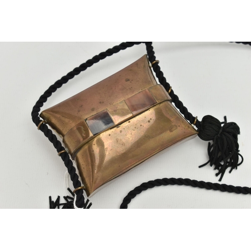 385A - AN ART DECO STYLE BRASS CUSHION SHAPED EVENING PURSE, on a tasselled black cord, lined interior, wid... 