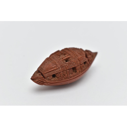 55A - A CHINESE HEDIAO NUT CARVED AS A BOAT, inscribed verso with Chinese script / poem, Qing period, leng... 