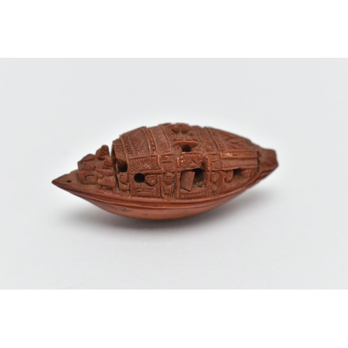 55A - A CHINESE HEDIAO NUT CARVED AS A BOAT, inscribed verso with Chinese script / poem, Qing period, leng... 