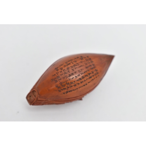 55A - A CHINESE HEDIAO NUT CARVED AS A BOAT, inscribed verso with Chinese script / poem, Qing period, leng... 