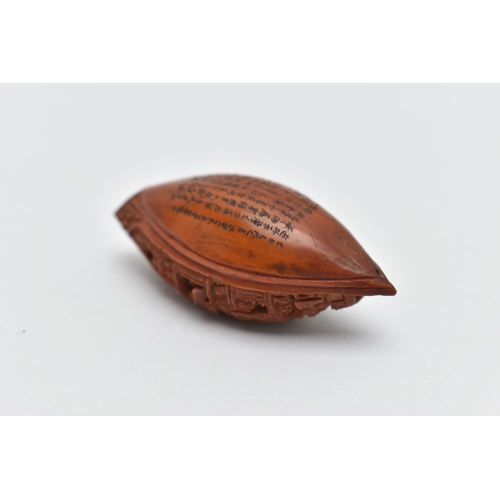 55A - A CHINESE HEDIAO NUT CARVED AS A BOAT, inscribed verso with Chinese script / poem, Qing period, leng... 