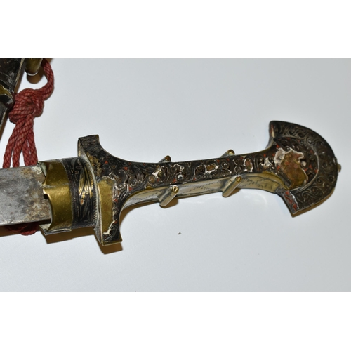 181 - AN ARAB JAMBIYA DAGGER, in its original  tooled scabbard with a flared end to its hilt and fitted wi... 