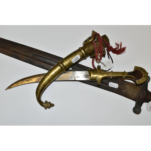 181 - AN ARAB JAMBIYA DAGGER, in its original  tooled scabbard with a flared end to its hilt and fitted wi... 