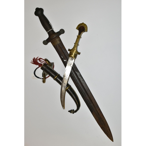 181 - AN ARAB JAMBIYA DAGGER, in its original  tooled scabbard with a flared end to its hilt and fitted wi... 