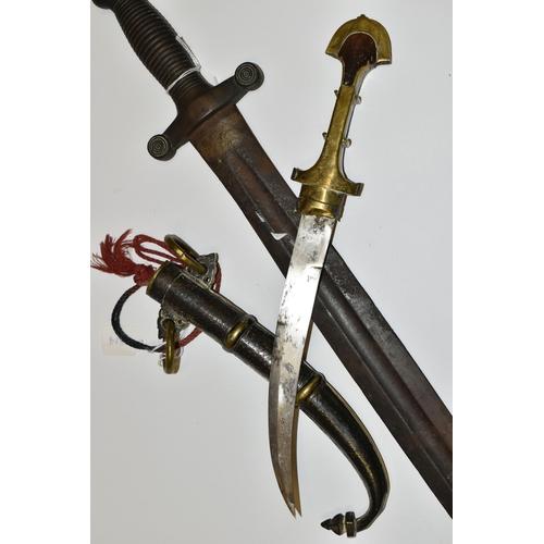 181 - AN ARAB JAMBIYA DAGGER, in its original  tooled scabbard with a flared end to its hilt and fitted wi... 