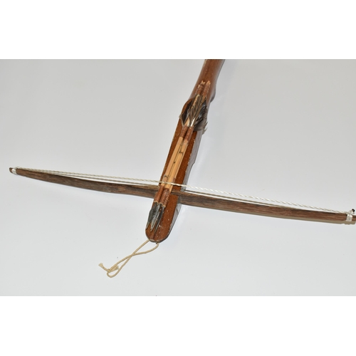 190 - A SMALL CROSSBOW, in working order complete with four arrows, the stock is engraved Philippines but ... 