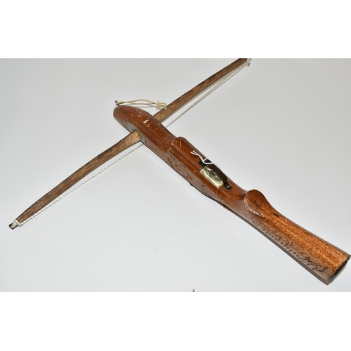 190 - A SMALL CROSSBOW, in working order complete with four arrows, the stock is engraved Philippines but ... 