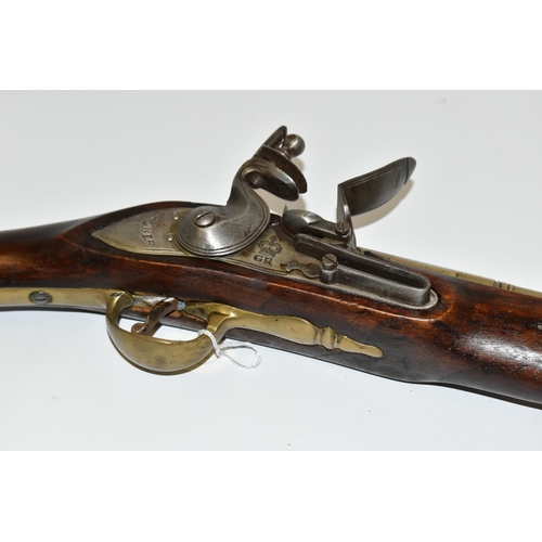 202 - AN OLD REPLICA OF A BRASS BARREL FLINTLOCK BLUNDERBUSS, only bored through for part of its barrel le... 