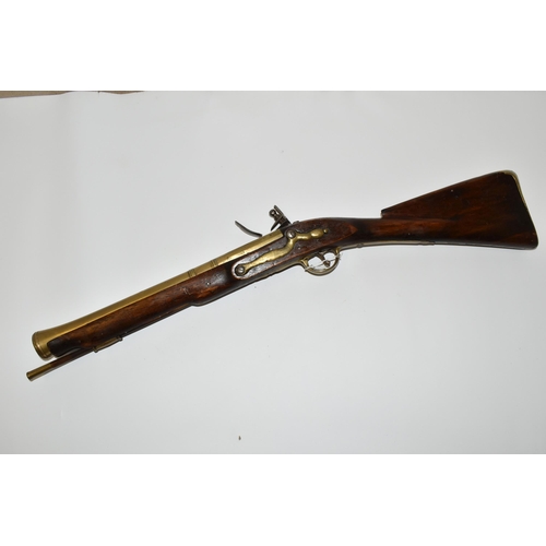 202 - AN OLD REPLICA OF A BRASS BARREL FLINTLOCK BLUNDERBUSS, only bored through for part of its barrel le... 