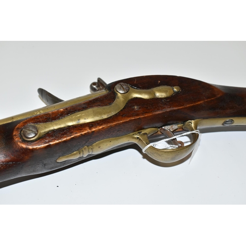 202 - AN OLD REPLICA OF A BRASS BARREL FLINTLOCK BLUNDERBUSS, only bored through for part of its barrel le... 