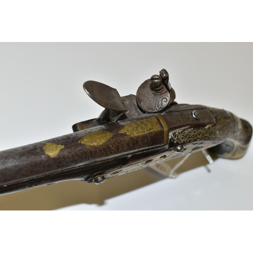 216 - AN ANTIQUE 20 BORE TURKISH FLINTLOCK HOLSTER PISTOL FITTED WITH A 12'' BARREL, its stock is nicely i... 