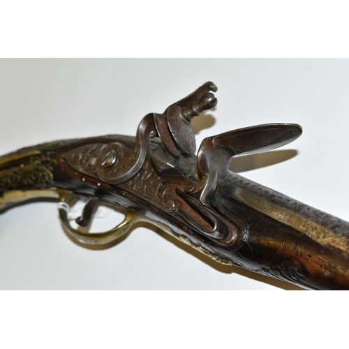 216 - AN ANTIQUE 20 BORE TURKISH FLINTLOCK HOLSTER PISTOL FITTED WITH A 12'' BARREL, its stock is nicely i... 