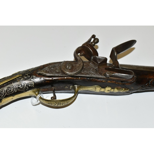 216 - AN ANTIQUE 20 BORE TURKISH FLINTLOCK HOLSTER PISTOL FITTED WITH A 12'' BARREL, its stock is nicely i... 