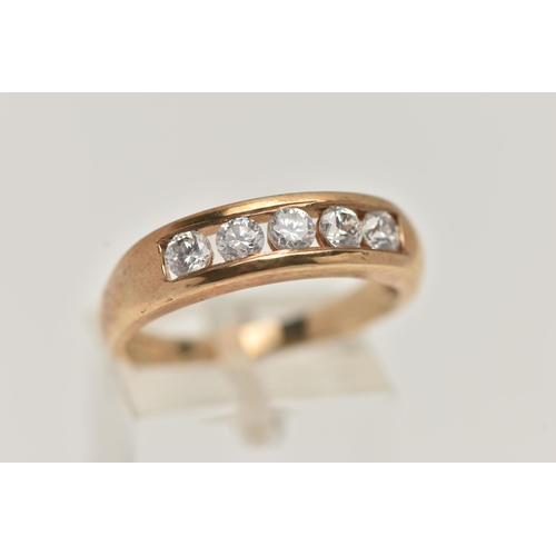 1 - A 9CT GOLD CUBIC ZIRCONIA RING, designed with  row of five circular cut, colourless cubic zirconia, ... 