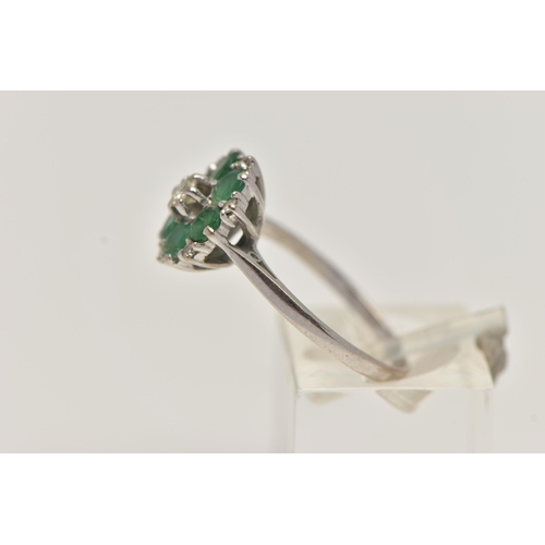 27 - A WHITE METAL EMERALD AND DIAMOND CLUSTER RING, circular cluster, set with a central raised round br... 