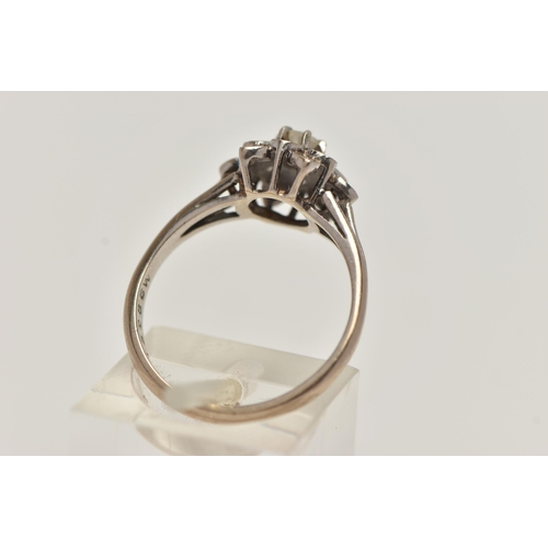 28 - A WHITE METAL DIAMOND CLUSTER RING, of a flower shape, set with a central round brilliant cut diamon... 