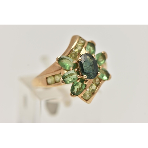 34 - A 9CT GOLD GEM SET RING, dress ring set with a central oval cut green sapphire, within a surround of... 