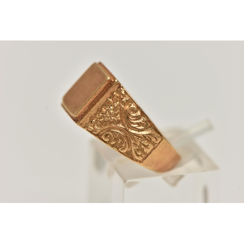 48 - A YELLOW METAL SIGNET RING, polished rectangular signet to scrolling floral shoulders and polished b... 