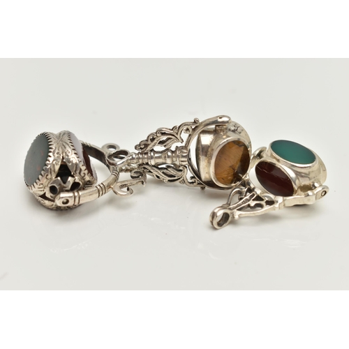 84 - THREE WHITE METAL SWIVEL FOB PENDANTS, each set with semi-precious gemstones such as bloodstone, car... 