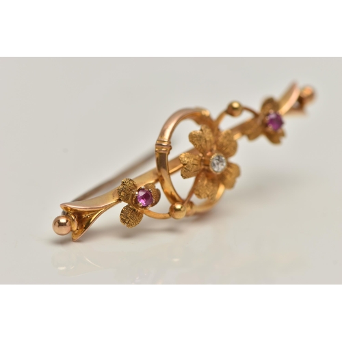 86 - AN EARLY 20TH CENTURY 15CT GOLD BAR BROOCH, floral bar brooch set with a single old cut diamond and ... 