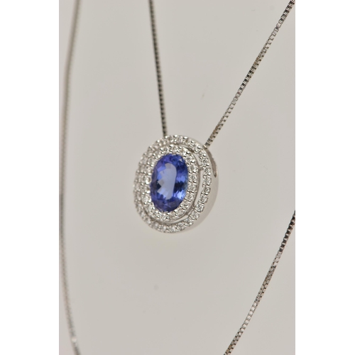 99 - AN 18CT WHITE GOLD, TANZANITE AND DIAMOND CLUSTER PENDANT NECKLACE, the pendant of an oval form, set... 