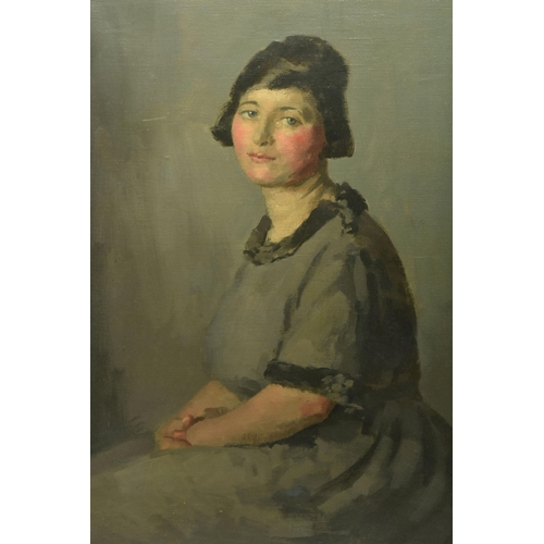 318 - JOHN WHEATLEY (1892-1955) A SEATED PORTRAIT OF A FEMALE FIGURE, she is gazing straight at the viewer... 